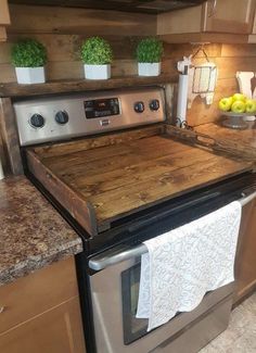 a kitchen with an oven and counter tops made out of wooden planks on top of the stove