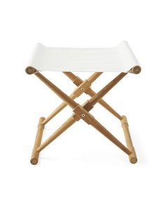 a small white tray with wooden legs on a white background for use as a stool