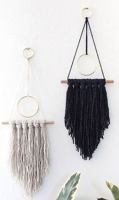 three macrame wall hangings on a white wall