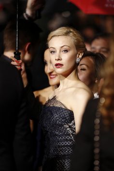 a woman in a black dress holding an umbrella