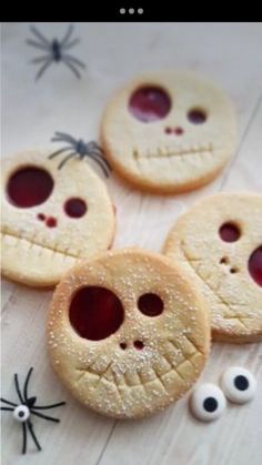 four cookies decorated like faces and eyes with googly eyes