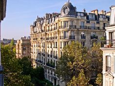 an apartment building with many windows and balconies on the top floor in paris