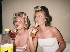 two women in bathing suits drinking from bottles