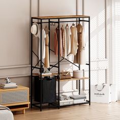 an open closet with clothes hanging on the rack and other items in front of it