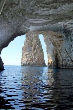 an image of the inside of a cave in the ocean with water and rock formations