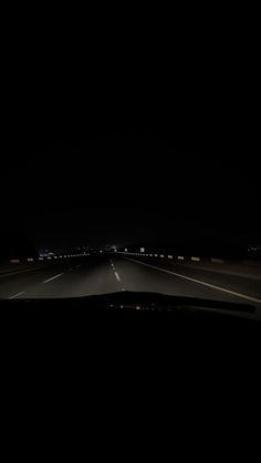 an empty highway at night in the dark