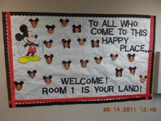 a bulletin board with mickey mouses on it in an office cubicle area that says, to all who come to this happy place, room 1 is your land