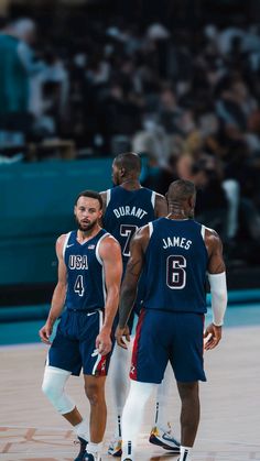 three basketball players are standing on the court