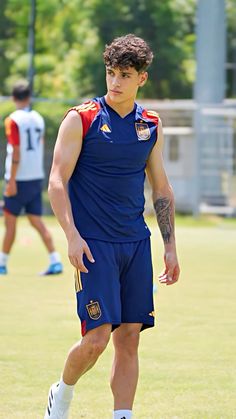 a young man standing on top of a soccer field