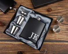 a flask and shot glass in a black gift box with monogrammed initials