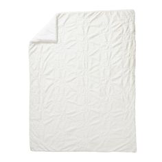 a white quilted blanket on a white background