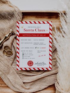 a red and white striped business card next to a pair of scissors