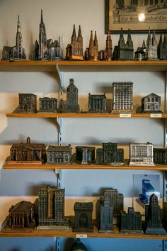 several shelves with model buildings on them