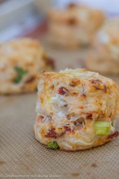 some food that is sitting on top of a piece of parchment paper with other food items in the background