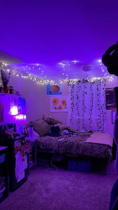 a bedroom with purple lights and a leopard print bed spread on the carpeted floor