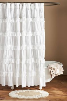 a white shower curtain with ruffles on it