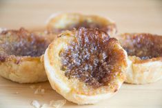 three small pastries sitting on top of a wooden table