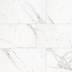 white marble tiles with grey veining on the edges and bottom, all in different sizes