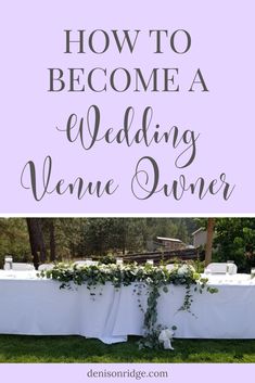 a table set up for a wedding with flowers and greenery on it, in front of