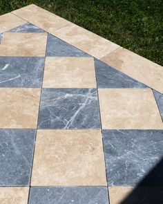 a black and white checkerboard pattern is shown on the ground with grass in the background