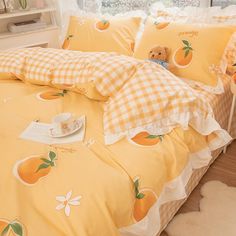 a bed with yellow comforters and pillows on it