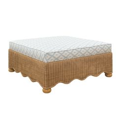 a wicker ottoman with a blue and white cover