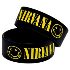 two black wristbands with yellow nirvana on the front and one has a smiley face