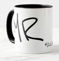 a black and white coffee mug with the letter k on it