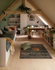 an attic living room with wood floors and green walls