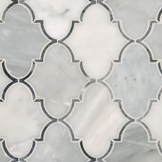 a white and black tile with an intricate design on the bottom half, in grey tones