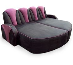 a black and pink couch sitting on top of a white floor