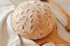 a loaf of bread sitting on top of a wooden cutting board