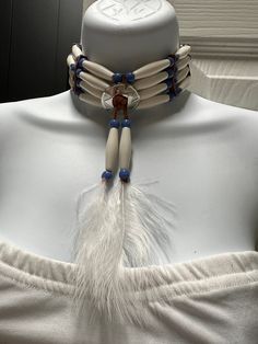 This handmade necklace showcases a unique blend of Western and Native Indian styles. The choker design is crafted from high-quality leather, making it a durable and stylish accessory. The piece was made in the United States, adding to its authenticity and appeal. The necklace is perfect for those who appreciate the beauty and complexity of handmade jewelry. Native American Bone Jewelry, Native American Accessories, Native Accessories, Native American Style Outfits, Bone Choker, Choker Design, Indian Beadwork, Leather Making, Choker Designs