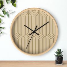 a clock on the wall next to a potted plant