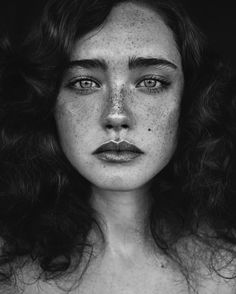 a woman with freckles on her face