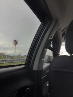 the back seat of a car on a rainy day