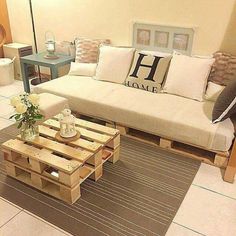 a living room filled with lots of furniture next to a white couch and coffee table