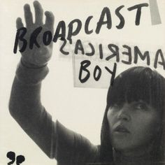 a woman holding up a sign with the words barack obama written on it in black and white