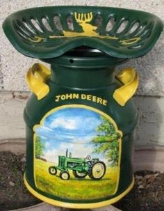 a green jar with a tractor painted on it