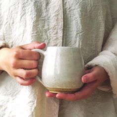 a person holding a cup in their hands