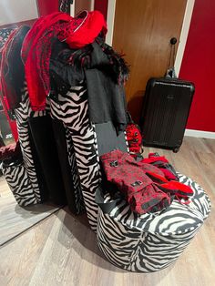 a zebra print chair with red and black accessories