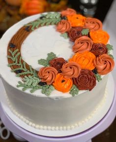 there is a white cake with orange flowers on it