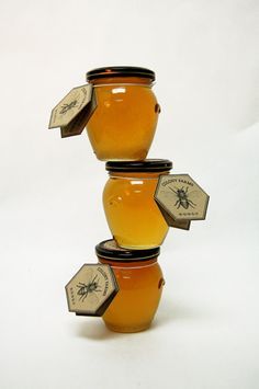 three honey jars stacked on top of each other