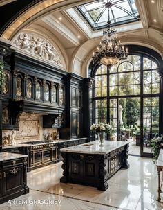 an ornate kitchen with black cabinets and marble counter tops, chandelier, large windows, and potted plants in the center