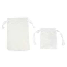 two white bags with ties on them sitting next to each other