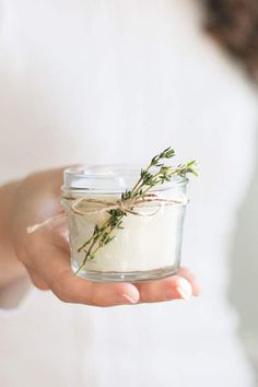 a person holding a jar with some kind of substance in it