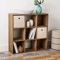 a wooden shelf with several cubes on it and a bowl sitting on the top