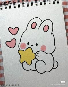 a drawing of a white bunny holding a star with hearts on it's back