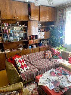 a living room filled with furniture and lots of clutter