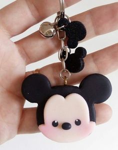 a hand holding a mickey mouse key chain